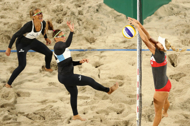 RIO DE JANEIRO, BRAZIL - AUGUST 10: Georgina Klug spikes as Ana Gallay of Argentina looks as Marketa Slukova of Czech Republic blocks at the net during the Beach Volleyball - Women's Preliminary - Pool B, Match 26 on Day 5 of the Rio 2016 Olympic Games at the Beach Volleyball Arena on August 10, 2016 in Rio de Janeiro, Brazil. (Photo by Paul Gilham/Getty Images)