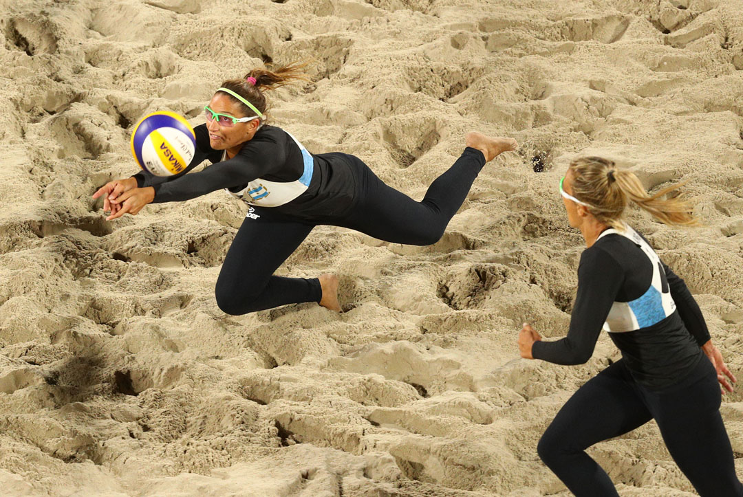 RIO DE JANEIRO, BRAZIL - AUGUST 10: Georgina Klug digs as Ana Gallay of Argentina waits to receive against Barbora Hermannova and Marketa Slukova of Czech Republic during the Beach Volleyball - Women's Preliminary - Pool B, Match 26 on Day 5 of the Rio 2016 Olympic Games at the Beach Volleyball Arena on August 10, 2016 in Rio de Janeiro, Brazil. (Photo by Paul Gilham/Getty Images)